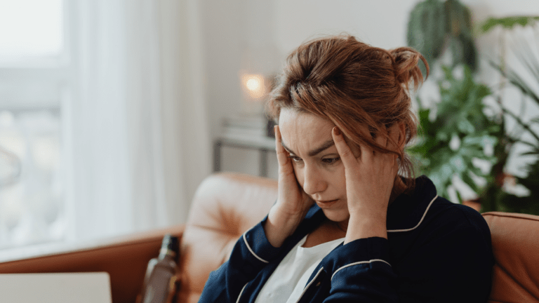 A person with their hands on their head