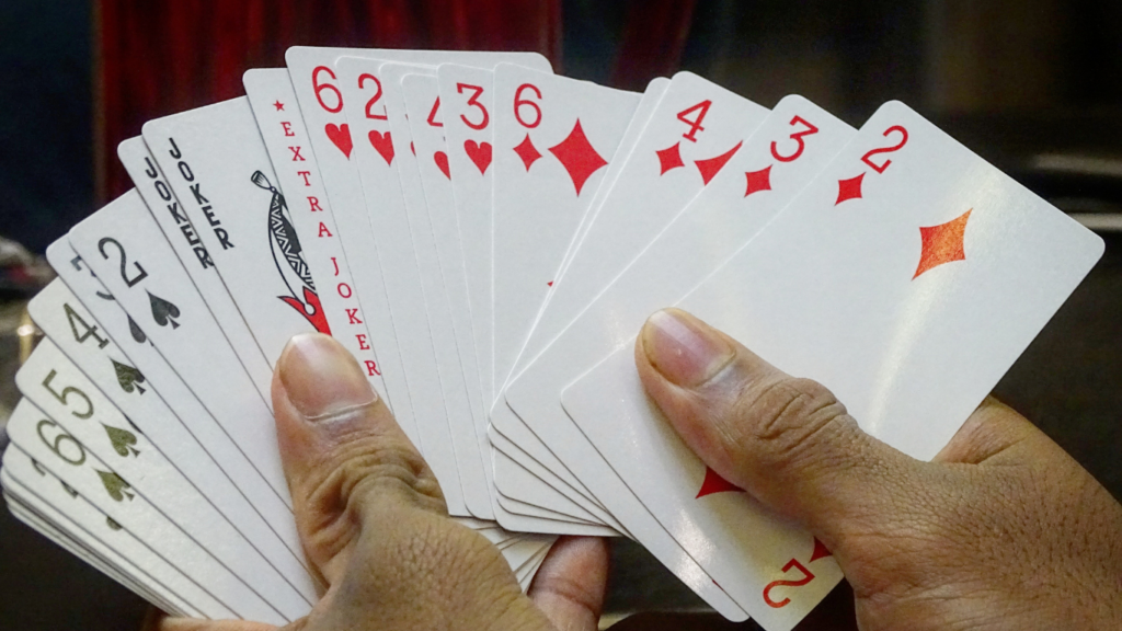 a person holding a playing cards